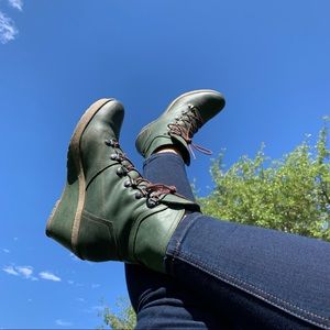 Green lace-up wedge booties.